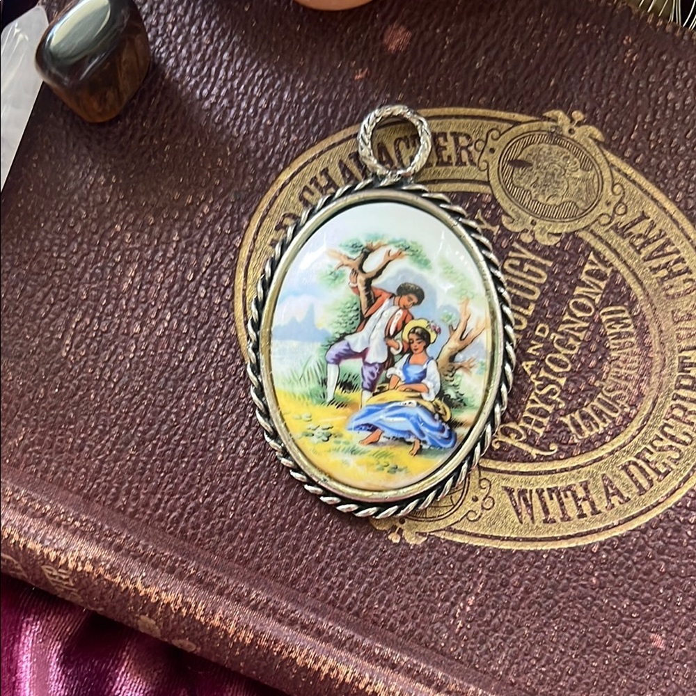 Charming antique Limoges porcelain pendant with silver rope frame.